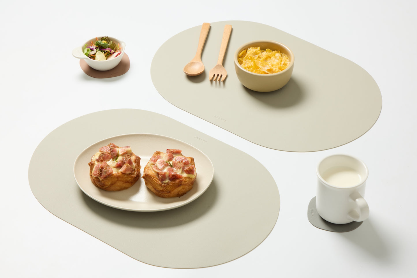 25 ROOF beige oval silicone placemats with matching coasters styled with breakfast — modern minimalist tabletop styling, set of 4
